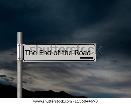 The end of the road, sign over dark, gloomhy cloud sky background. Concept, politics,, Brexit etc.