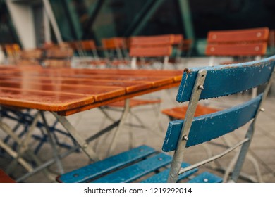 The End Of Season In Beer Garden With Rain Drop On Wooden Chair During Late Autumn Morning