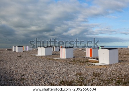 End of season on the beach, Le Havre, France. Small houses or beach cabins of different colors on the beach of Le Havre in France