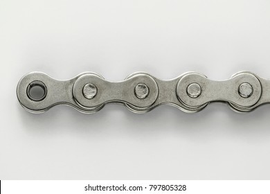 End Of A Silver Metal Bike Chain On A White Background.