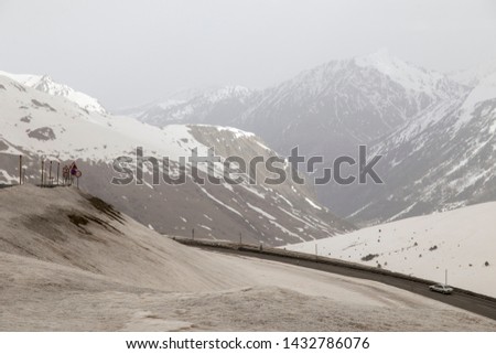 Similar – Image, Stock Photo Ski area with snow-covered mountains in the background