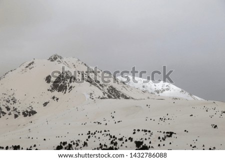 Similar – Image, Stock Photo Ski area with snow-covered mountains in the background