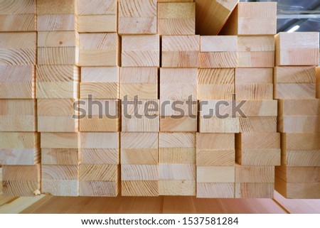 End view of stack of two-layer wooden glued laminated timber beams from pine finger joint spliced boards for wooden windows