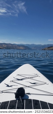 End of a white and black paddle board in Lake Chelan in Washington State