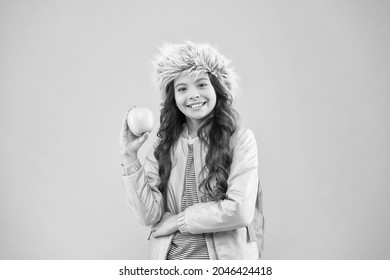 End Of Winter Semester. Holiday And Vacation. Kid Pink Backdrop. Teen Daily Life. Education And Happy People Schoolgirl With Books After Lesson. School Break. Small Happy Girl Earflap Hat Eat Apple