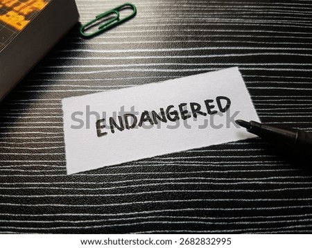 Endangered writting on table background.