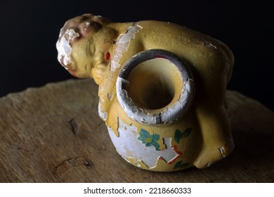 ENDEARING FIGURINE OF SLEEPING TODDLER DRAPED OVER A LARGE POT