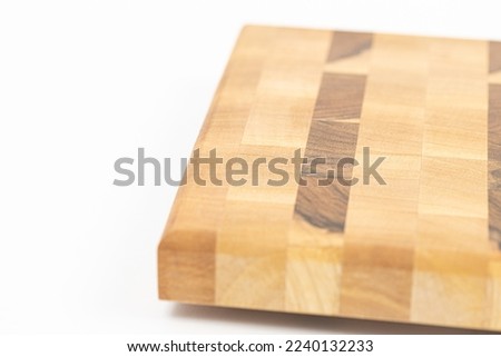 Endgrain cutting board isolated above white background.