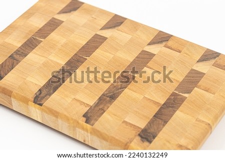 Endgrain cutting board isolated above white background.
