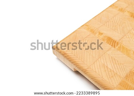 Endgrain wooden cutting board isolated above white background.