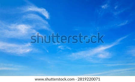 endless blue space filled with barely noticeable white fibers and arcs forming a peaceful natural background