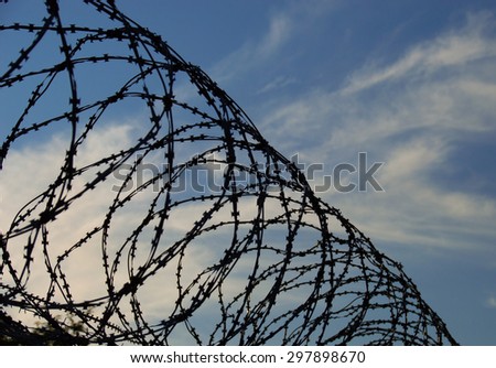 Similar – Fence with a barbed