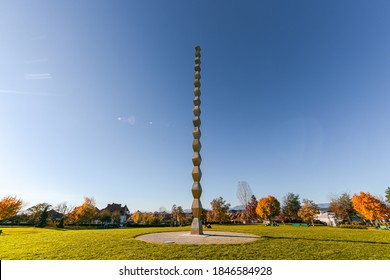 Endless Column (Coloana Inifitului) sculpture made by Constantin Brancusi during an autumn day with amazing fall colors and blue sky - perspective view