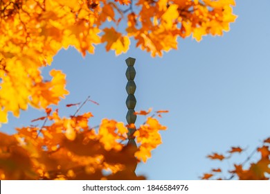 Endless Column (Coloana Inifitului) sculpture made by Constantin Brancusi during an autumn day with amazing fall colors and blue sky - perspective view