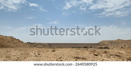 Endless Desert Expanse with Dramatic Cloud Formations