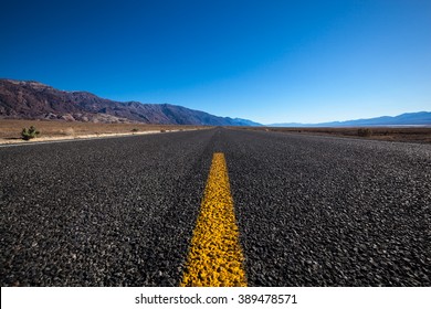 Endless Open Straight Road In Death Valley National Park  Low Angle