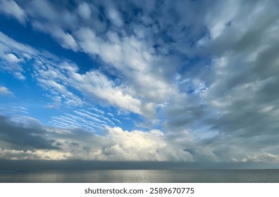 Endless Skies: Dramatic Cloudscape Over a Tranquil Wadden Sea, Where Blue Breaks Through