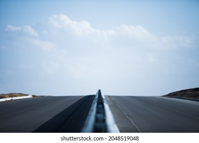 Endless Straight Road Running Through The Barren Scenery Of The With Extreme Heat Haze