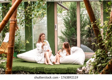 Endless Summer Cute Baby And Mother Relaxing At Sunbed Near Pool At Resort. A Little Girl Wearing Sunglasses. Child And Mom Sunbathe. Fashion Girls, Friends, Family At Resort