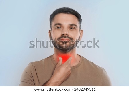 Endocrine system. Man doing thyroid self examination on light grey background