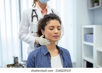 Endocrinologist examining throat of young woman in clinic. Women with thyroid gland test . Endocrinology, hormones and treatment. Inflammation of the sore throat - Powered by Shutterstock