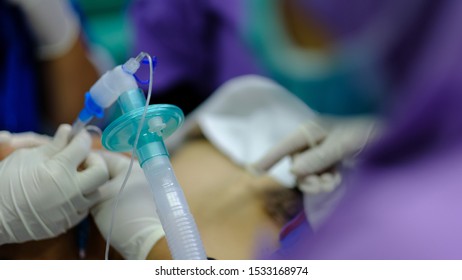Endotracheal tube being placed on blurry background of patient.