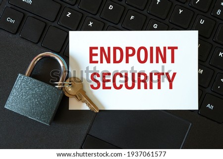 Endpoint Security - an inscription on a card and a lock on the background of a computer keyboard