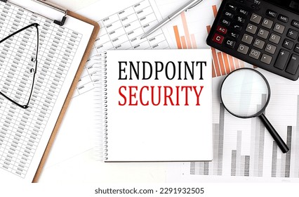 ENDPOINT SECURITY text on a notebook with clipboard and calculator on a chart background