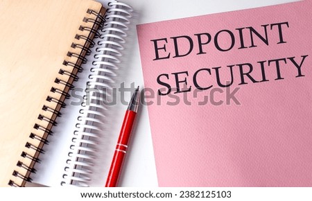 ENDPOINT SECURITY word on pink paper with office tools on white background
