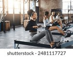 Endurance, gym and woman on rowing machine for health, wellness and body workout with class. Fitness, exercise and female athlete on ergometer equipment for cardio cross training in sports center.