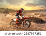 Enduro bike rider driving off road bike on sunset background. Preparing for competition. Training on motorbike. Extreme motorcycle