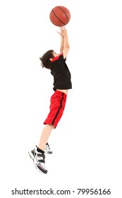 Energetic 8 year old boy child in basketball uniform jumping for shot.