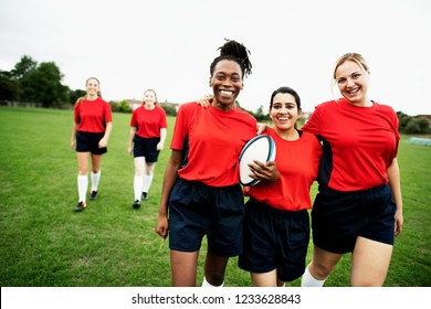 Energetic female rugby players walking together - Powered by Shutterstock