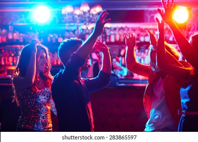 Energetic Friends Dancing In Night Club