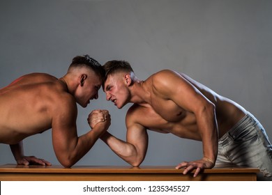 Energetic And Full Of Strength. Twins Men Competing Till Victory. Revenge In Sport. Twins Competitors Arm Wrestling. Men Competitors Try To Win Victory Or Revenge. Strength Skills.