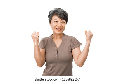 The Energetic Middle-aged White-haired Woman Celebrated Success, Amazed By Her Fist Raised Her Hands, YES. White Background. Active Elderly Concept.