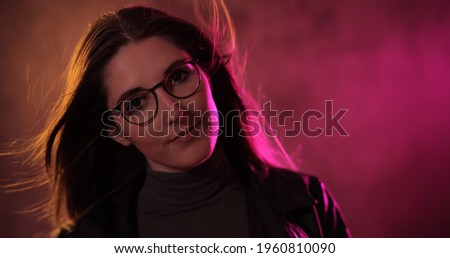 Energetic photo of a young woman with wild blond hair - studio photography