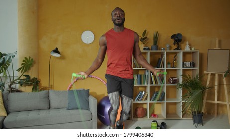 Energetic Young African American Athlete Jumps On Rope Performing Active Cardio Exercises Workout Cross Fit Training At Home.