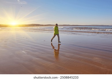 Energetic young man in a green jacket jogging along the ocean in Essaouira, Morocco. Enjoying the scenic coastline, embracing an active lifestyle - Powered by Shutterstock