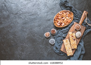 Energy Bars And Balls - Snack For Healthy Lifestyle On Black Background, Top View