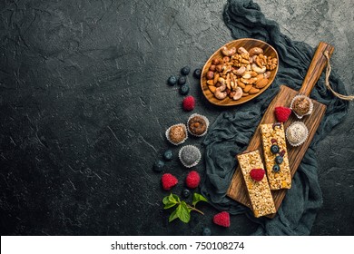 Energy Bars And Balls - Snack For Healthy Lifestyle On Black Background, Top View