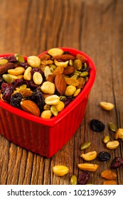 Energy Blend Trail Mix With Nuts And Dried Fruits In Heart Shaped Bowl. Selective Focus.