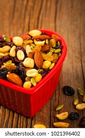 Energy Blend Trail Mix With Nuts And Dried Fruits In Heart Shaped Bowl. Selective Focus.