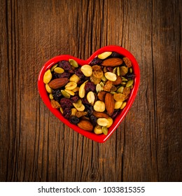 Energy Blend Trail Mix With Nuts And Dried Fruits In Heart Shaped Bowl. Selective Focus.