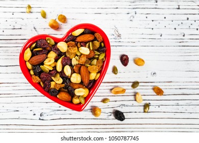 Energy Blend Trail Mix With Nuts And Dried Fruits In Heart Shaped Bowl. Selective Focus.