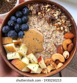 Energy Breakfast Of Oatmeal With Chia Milk Red Apple Walnut Cashew And Almond Butter Blueberry Honey
