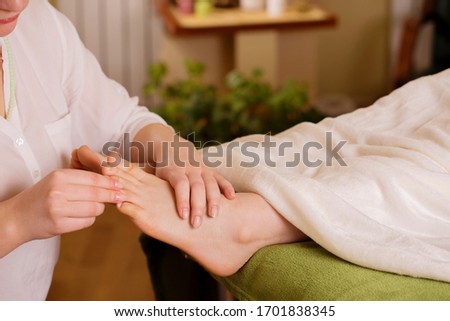 Energy cleansing feet in a stream of reiki. Foot massage