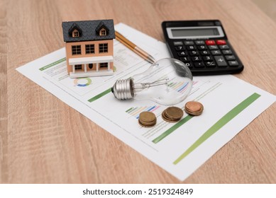 Energy Costs Concept with Light Bulb, Miniature House, Calculator and Coins on Electricity Bill, energy savings or home investment concept - Powered by Shutterstock