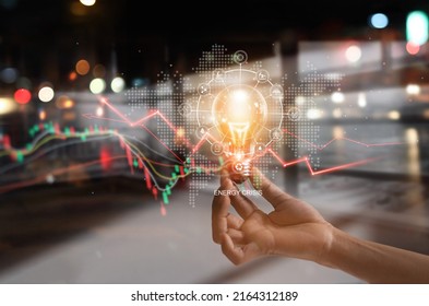 Energy crisis, Hand hold light bulb with energy resources icon and rising data chart representing electricity crisis, Economy   and alternative energy, Sustainability. Ecological friendly. 