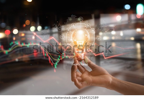 Energy crisis, Hand hold light bulb with energy\
resources icon and rising data chart representing electricity\
crisis, Economy   and alternative energy, Sustainability.\
Ecological friendly. 